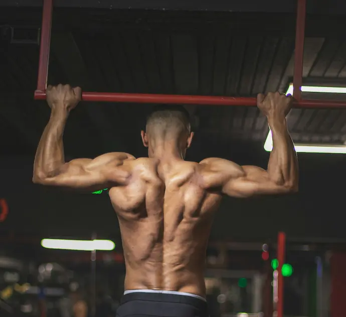 topless man in black shorts